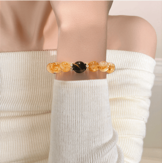 I Am Ready Citrine and Tiger Eye bracelet worn with white knit outfit in warm light