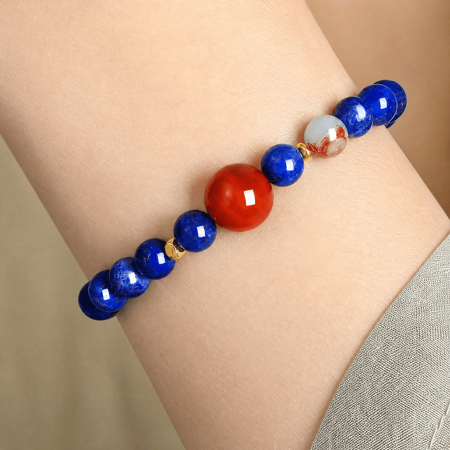 Close-up wrist image of Lapis Lazuli bracelet with red Nanhong bead and decorative multicolor accent bead
