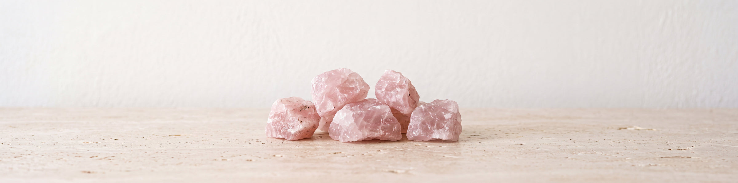 Raw rose quartz crystals with soft pink color for a gemstone bracelet collection
