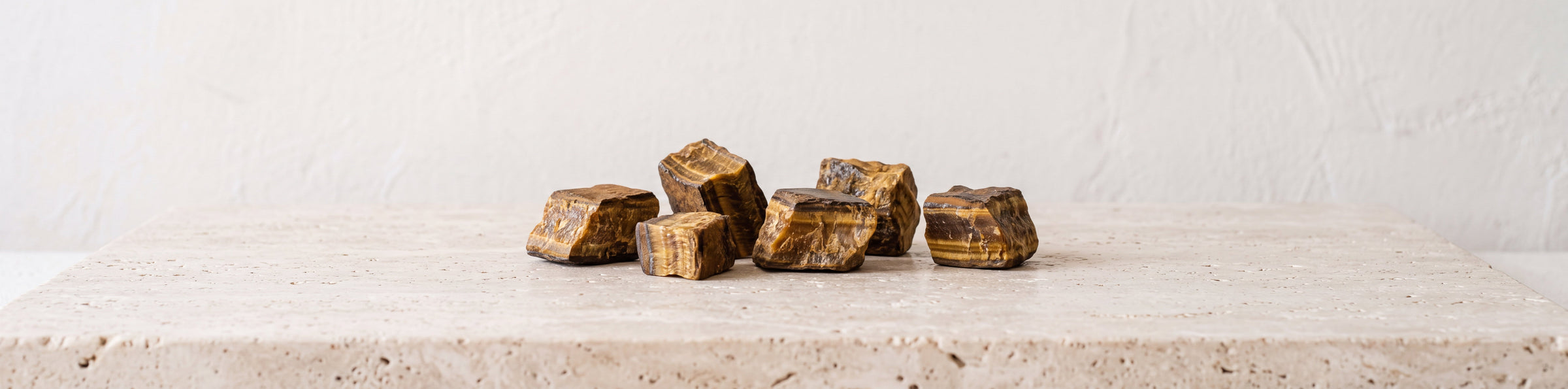 Raw tiger's eye stones with golden brown bands for a gemstone bracelet collection