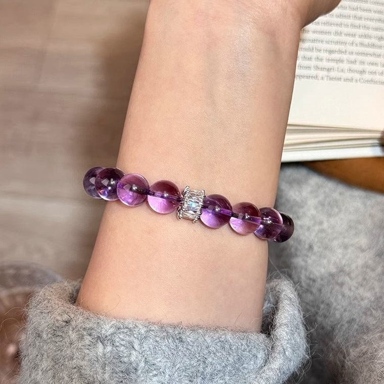 Close-up of A Clear Way Through bracelet worn on the wrist with 10mm Amethyst beads