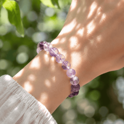 Close-up of A Quiet Return Amethyst bracelet worn in natural sunlight