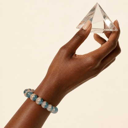 Blue Fluorite bracelet worn while holding a clear crystal prism in warm light