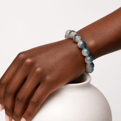 Natural Blue Fluorite bracelet worn on the wrist beside a white ceramic vase