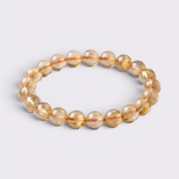 Natural Golden Rutilated Quartz citrine bracelet with 9-9.8mm golden yellow beads on a clean background