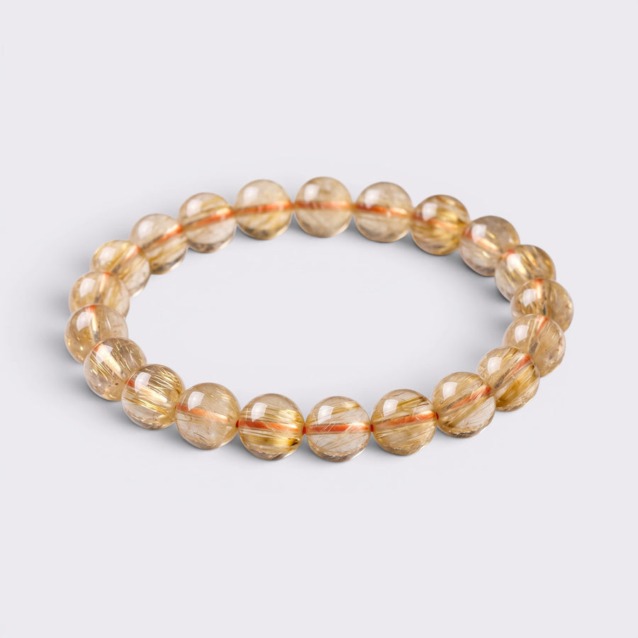 Natural Golden Rutilated Quartz citrine bracelet with 9-9.8mm golden yellow beads on a clean background
