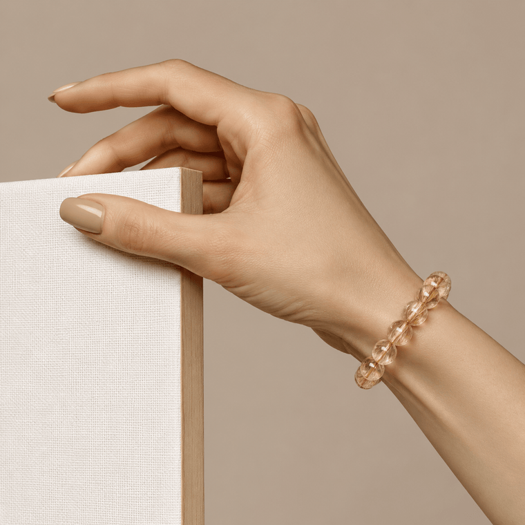 Golden Rutilated Quartz citrine bracelet worn on the wrist with a soft neutral styling background