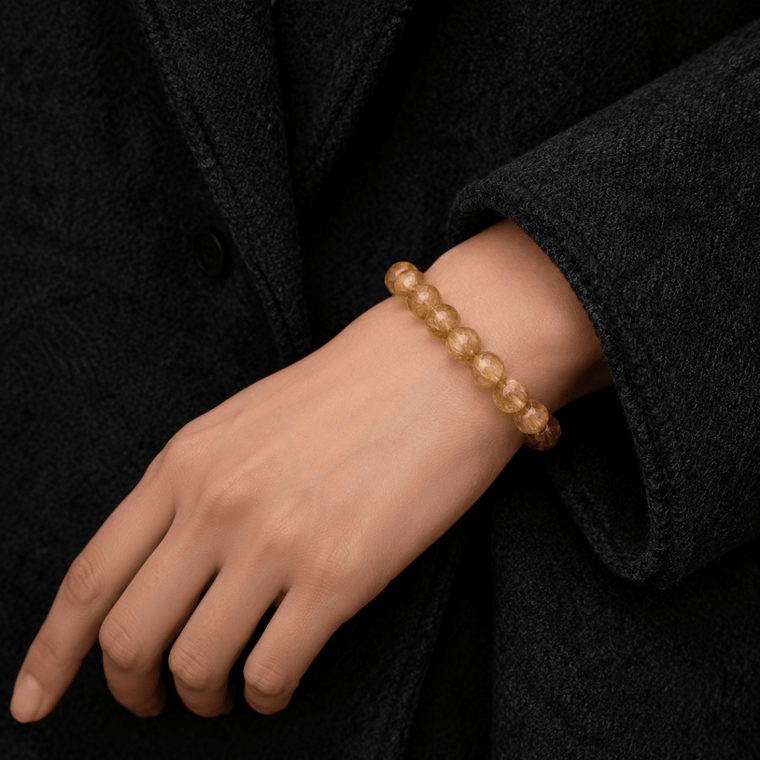 Natural golden yellow crystal bracelet styled with a black coat for everyday confidence and clarity