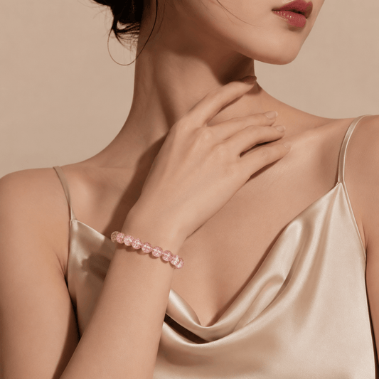 Woman wearing Good Things Find Me Pink Super Seven crystal bracelet with champagne satin dress