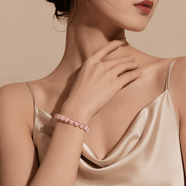 Woman wearing Good Things Find Me Pink Super Seven crystal bracelet with champagne satin dress