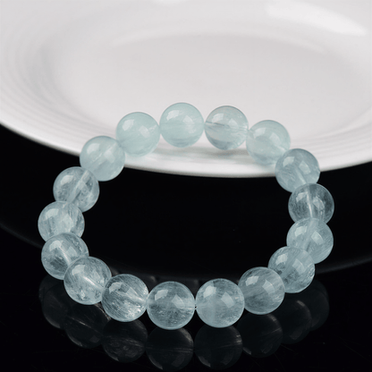 12mm Green Fluorite bracelet displayed on a black reflective surface