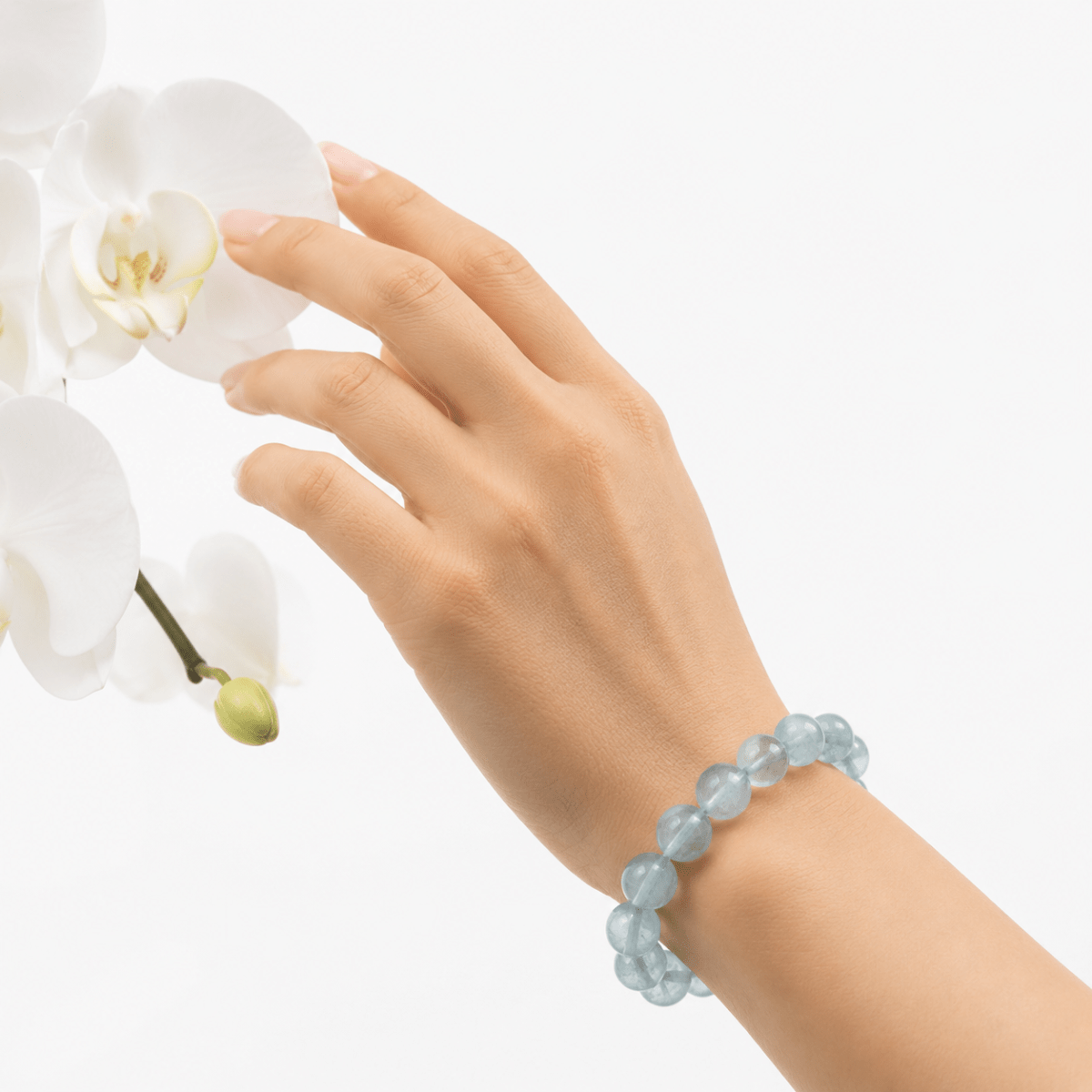 Natural Green Fluorite bracelet worn beside delicate white orchids