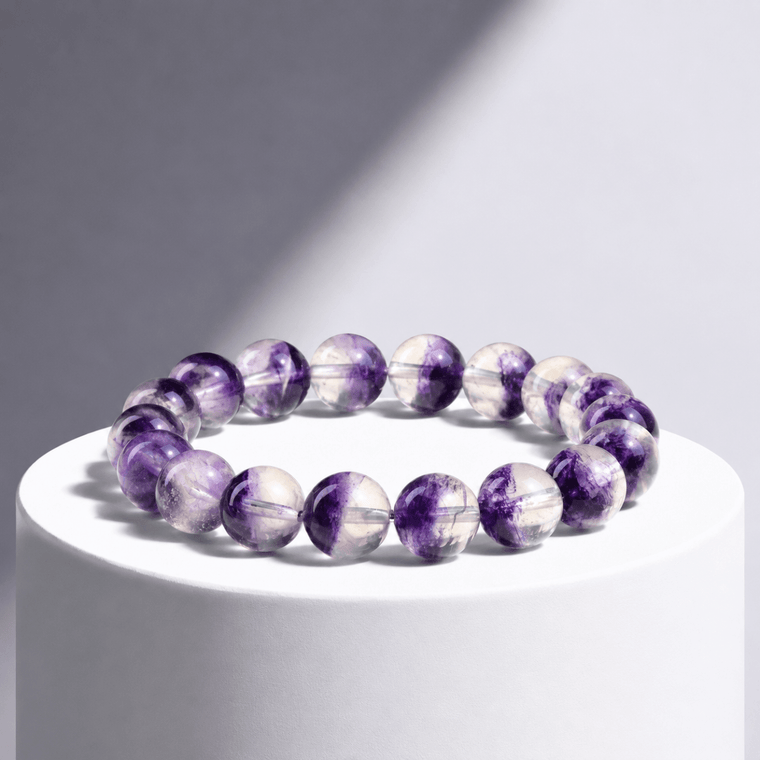 Natural Purple Fluorite bracelet displayed on a white pedestal in directional light
