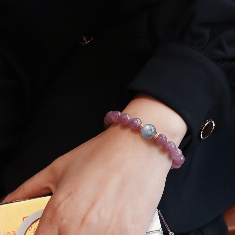 Held by the Moon bracelet worn with dark sleeve, highlighting the Gray Moonstone focal bead