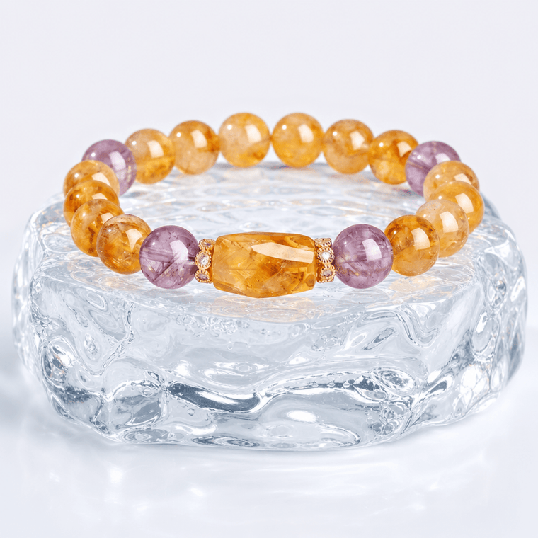 Natural Citrine and Amethyst bracelet displayed on a clear crystal glass stand