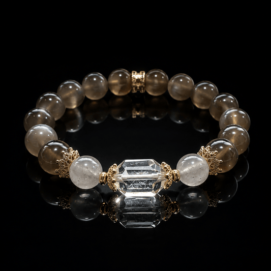 Gray Moonstone bracelet with faceted Clear Quartz focal bead displayed on black reflective surface