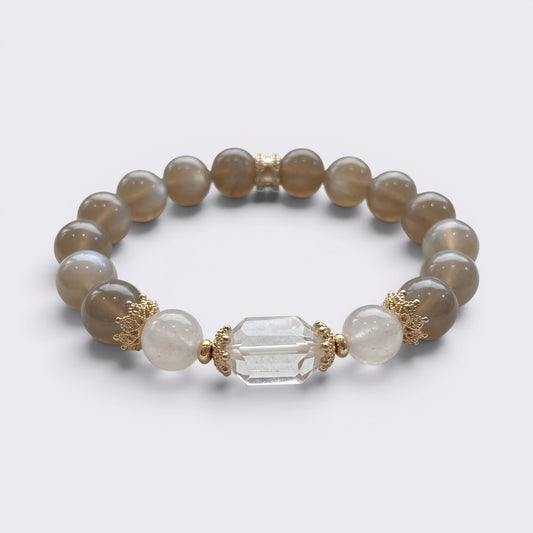 Front view of I Am Grounded in Light bracelet with 10mm Gray Moonstone beads, Clear Quartz accents, and gold-tone copper alloy details