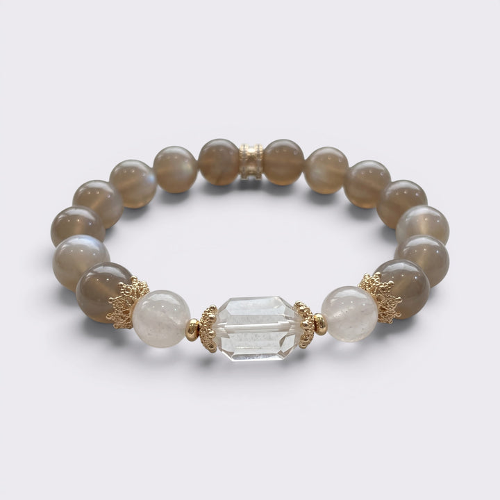 Front view of I Am Grounded in Light bracelet with 10mm Gray Moonstone beads, Clear Quartz accents, and gold-tone copper alloy details