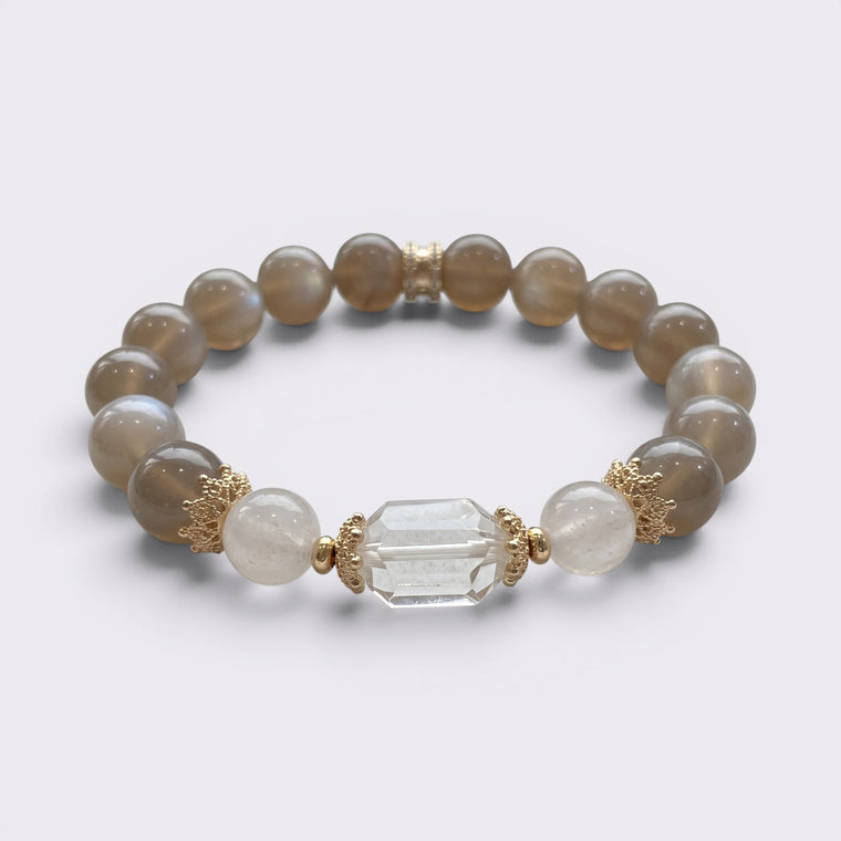 Front view of I Am Grounded in Light bracelet with 10mm Gray Moonstone beads, Clear Quartz accents, and gold-tone copper alloy details