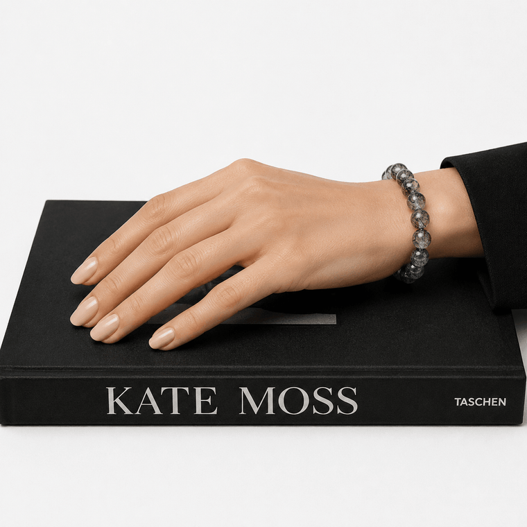 Woman wearing I Am Protected Black Rutilated Quartz bracelet styled on a black fashion book