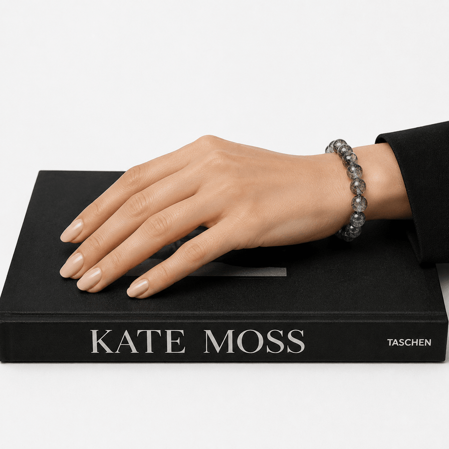 Woman wearing I Am Protected Black Rutilated Quartz bracelet styled on a black fashion book