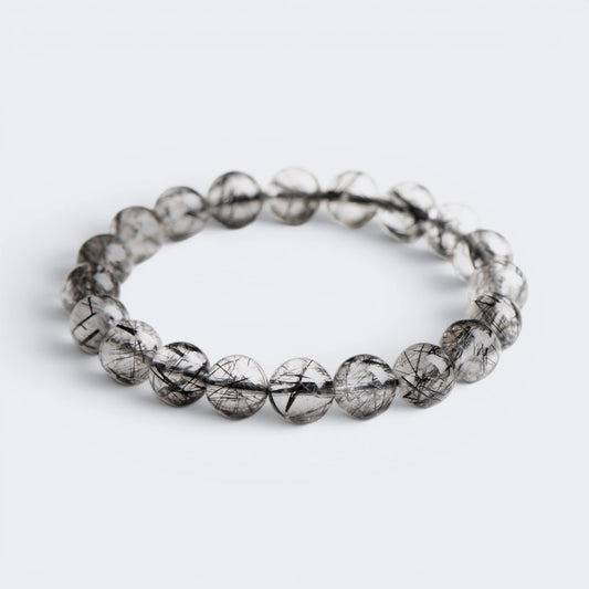Front view of I Am Protected bracelet with 10mm 7A Ice Black Rutilated Quartz beads and black needle inclusions