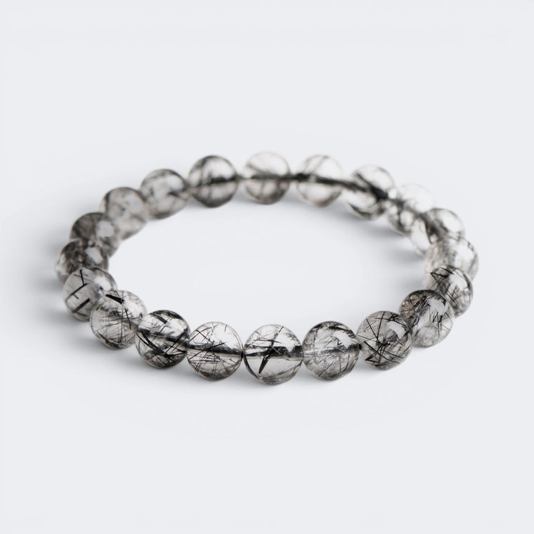 Front view of I Am Protected bracelet with 10mm 7A Ice Black Rutilated Quartz beads and black needle inclusions
