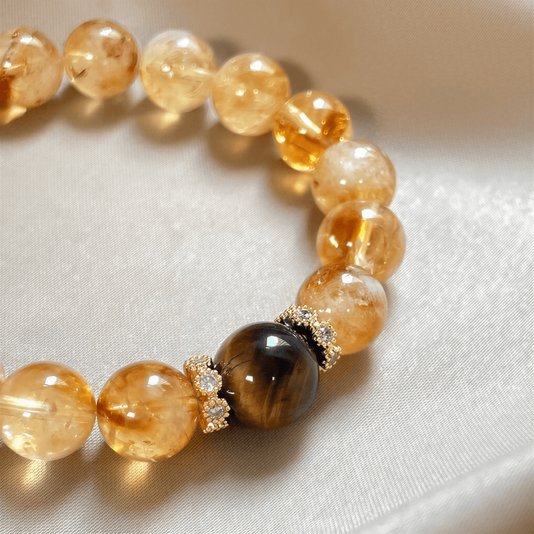 Close-up of Tiger Eye focal bead and gold-tone crystal spacer accents on I Am Ready Citrine bracelet