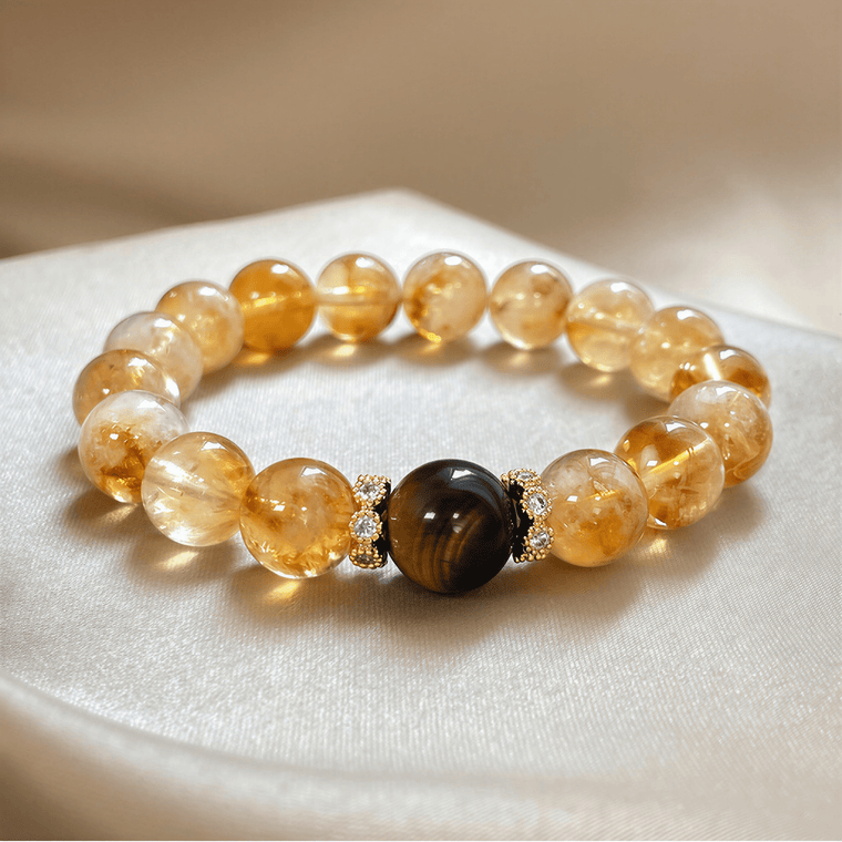 I Am Ready Citrine and Tiger Eye bracelet displayed on soft satin with golden crystal beads