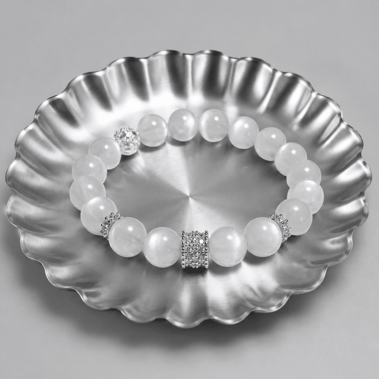 Natural Moonstone bracelet displayed on a silver scalloped tray with textured spacer accents