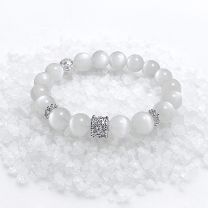 Natural Moonstone bracelet displayed on white crystal stones with silver-tone accents