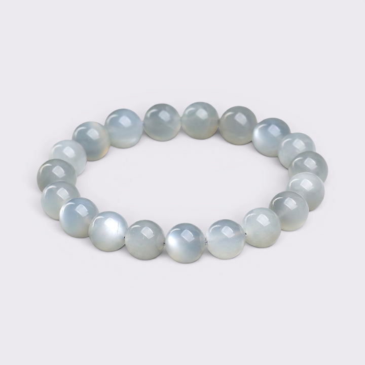 Front view of I Begin Again bracelet with 10mm natural White Moonstone beads on a clean background