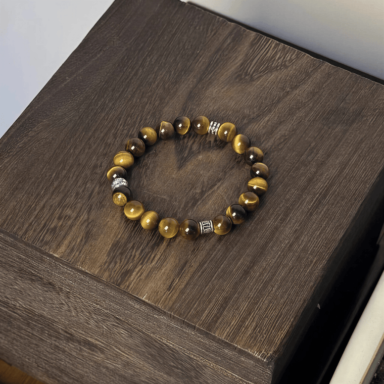 Tiger's Eye bracelet displayed on a dark wooden surface