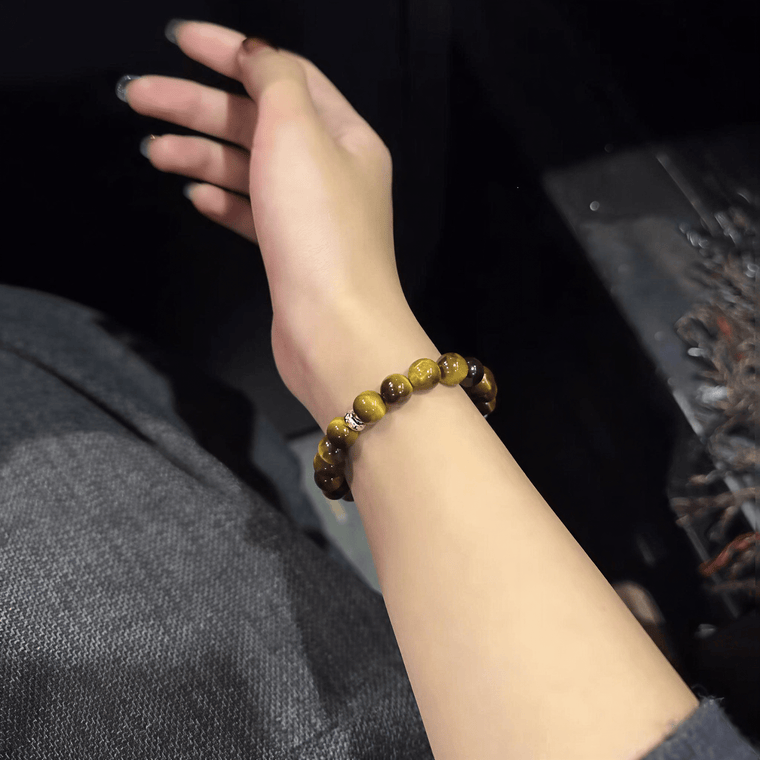 Close-up of natural Tiger's Eye bracelet worn on the wrist