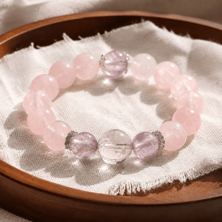 I Let Love In bracelet displayed on a wooden tray with natural Mozambique Rose Quartz and Amethyst beads