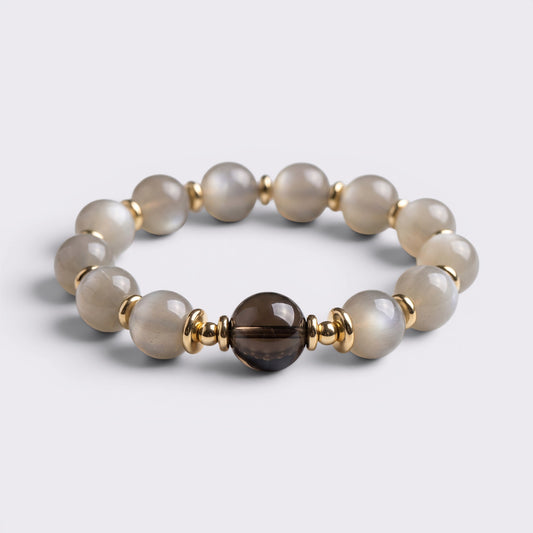 Front view of I Return to Stillness bracelet with 15-16mm Gray Moonstone beads, Smoky Quartz focal bead, and gold-tone accents