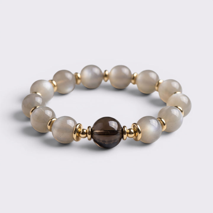 Front view of I Return to Stillness bracelet with 15-16mm Gray Moonstone beads, Smoky Quartz focal bead, and gold-tone accents