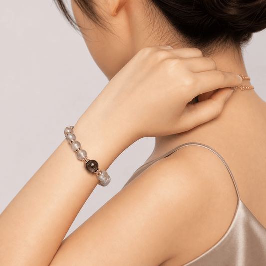 Gray Moonstone and Smoky Quartz bracelet worn on wrist with soft satin styling