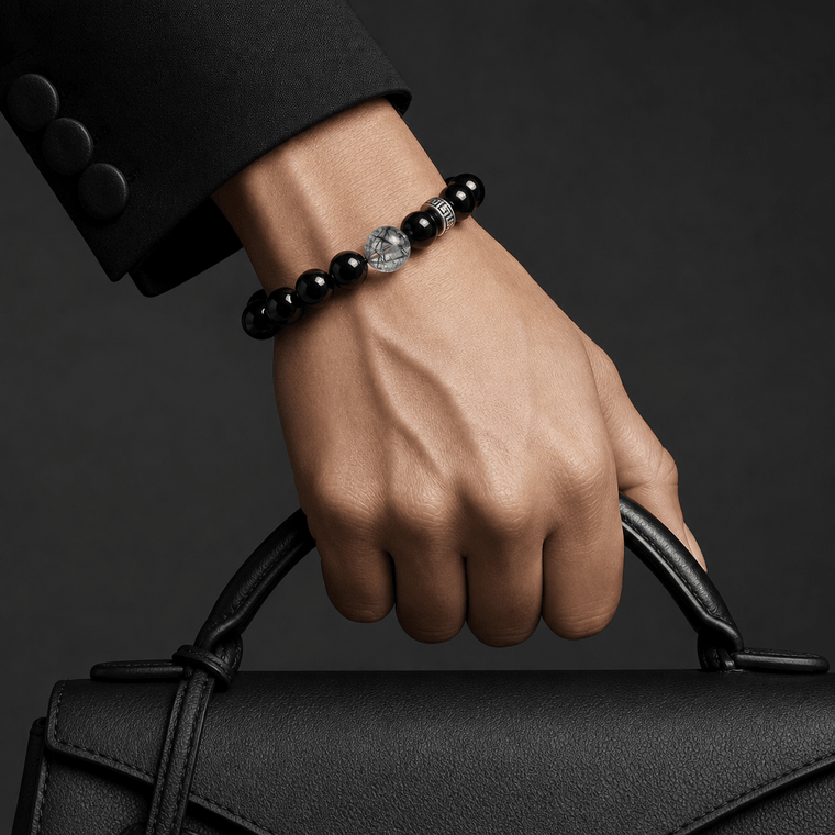 Woman wearing I Stand Clear black crystal bracelet while holding a black leather bag