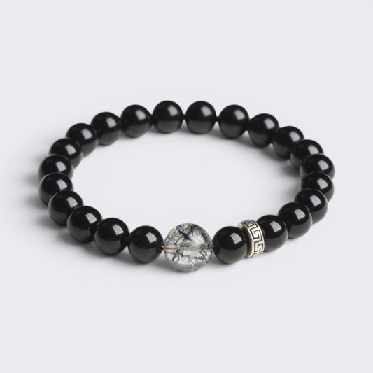 Front view of I Stand Clear bracelet with 8mm natural Obsidian beads, Black Rutilated Quartz focal bead, and S925 silver accent