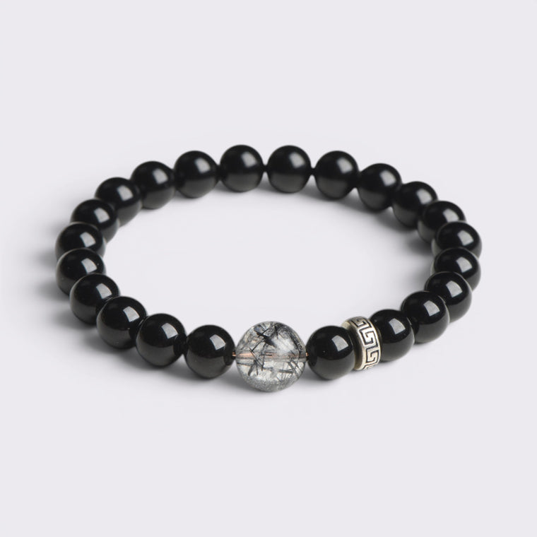 Front view of I Stand Clear bracelet with 8mm natural Obsidian beads, Black Rutilated Quartz focal bead, and S925 silver accent
