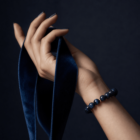 Natural Blue Tiger's Eye bracelet worn on wrist with deep blue velvet ribbon styling