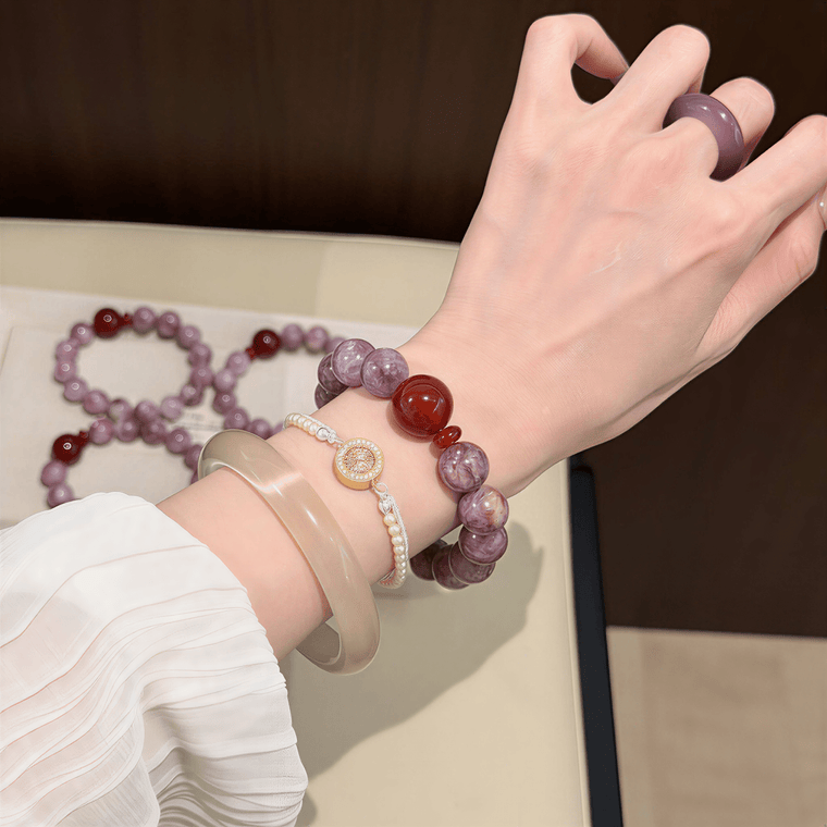 Woman wearing I Trust My Fire Amethyst bracelet in a lifestyle setting with layered accessories