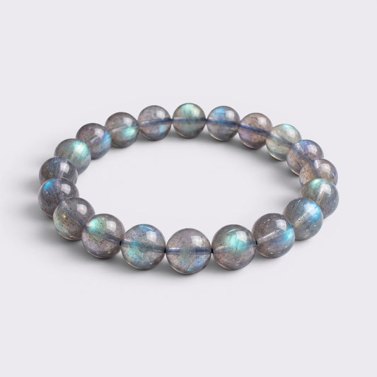Front view of I Trust My Rhythm bracelet with 10mm high-grade icy Blue Flash Gray Moonstone beads on a clean background