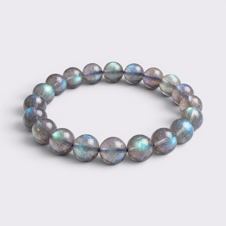 Front view of I Trust My Rhythm bracelet with 10mm high-grade icy Blue Flash Gray Moonstone beads on a clean background