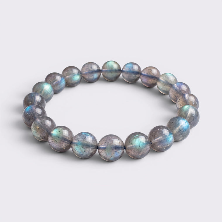 Front view of I Trust My Rhythm bracelet with 10mm high-grade icy Blue Flash Gray Moonstone beads on a clean background