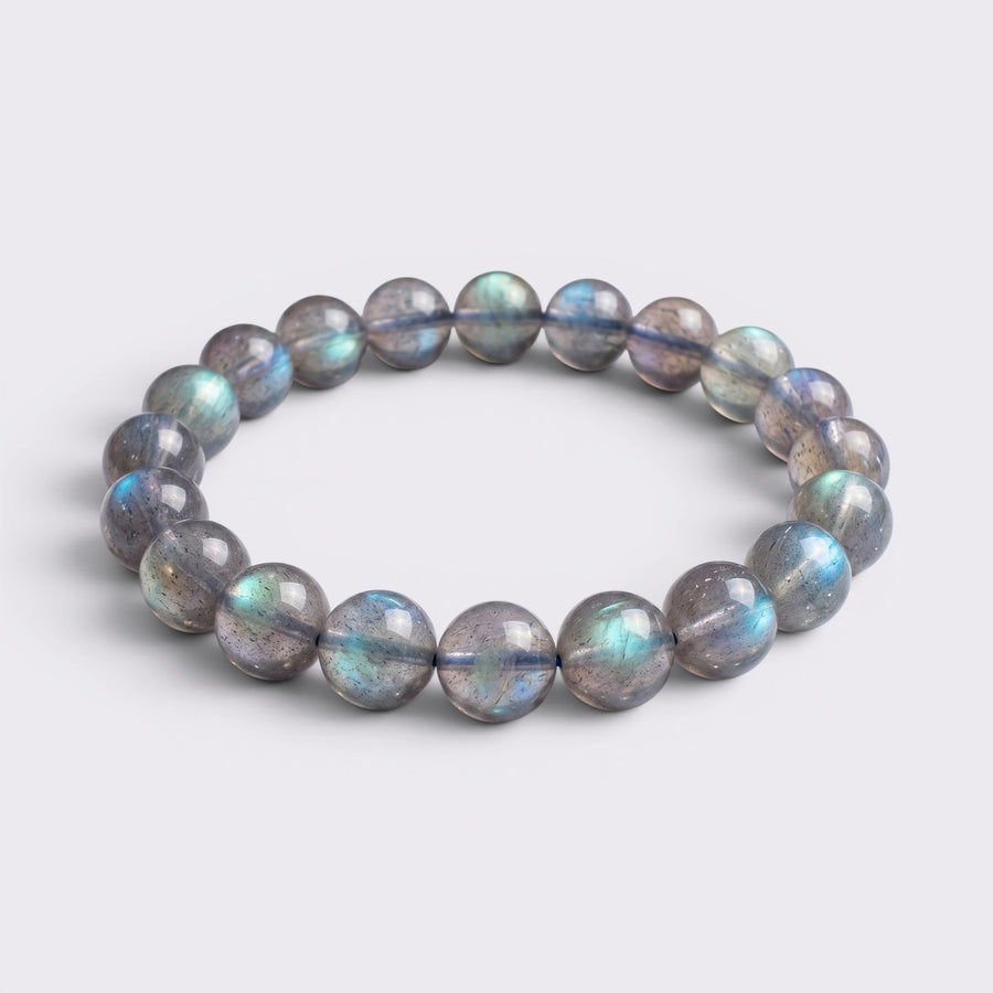 Front view of I Trust My Rhythm bracelet with 10mm high-grade icy Blue Flash Gray Moonstone beads on a clean background