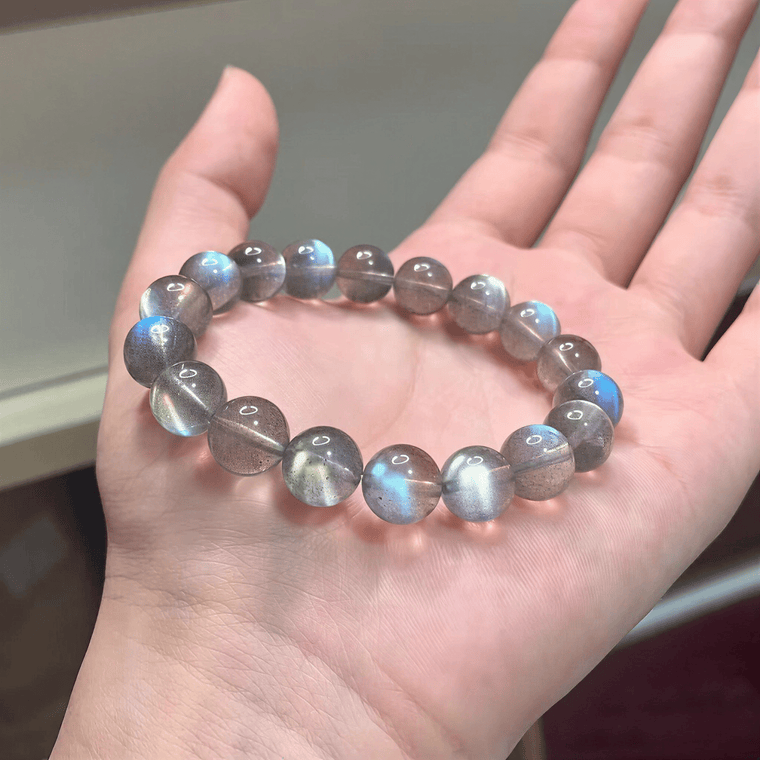 Natural Gray Moonstone bracelet with blue flash shown in hand for bead detail