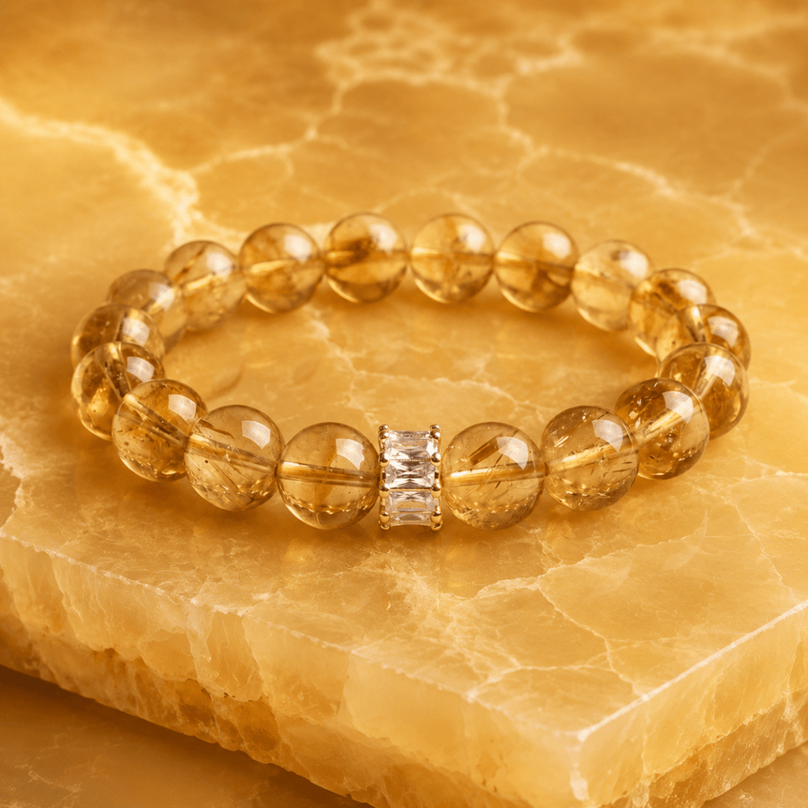 I Welcome More natural Citrine bracelet displayed on golden stone slab with clear crystal accent