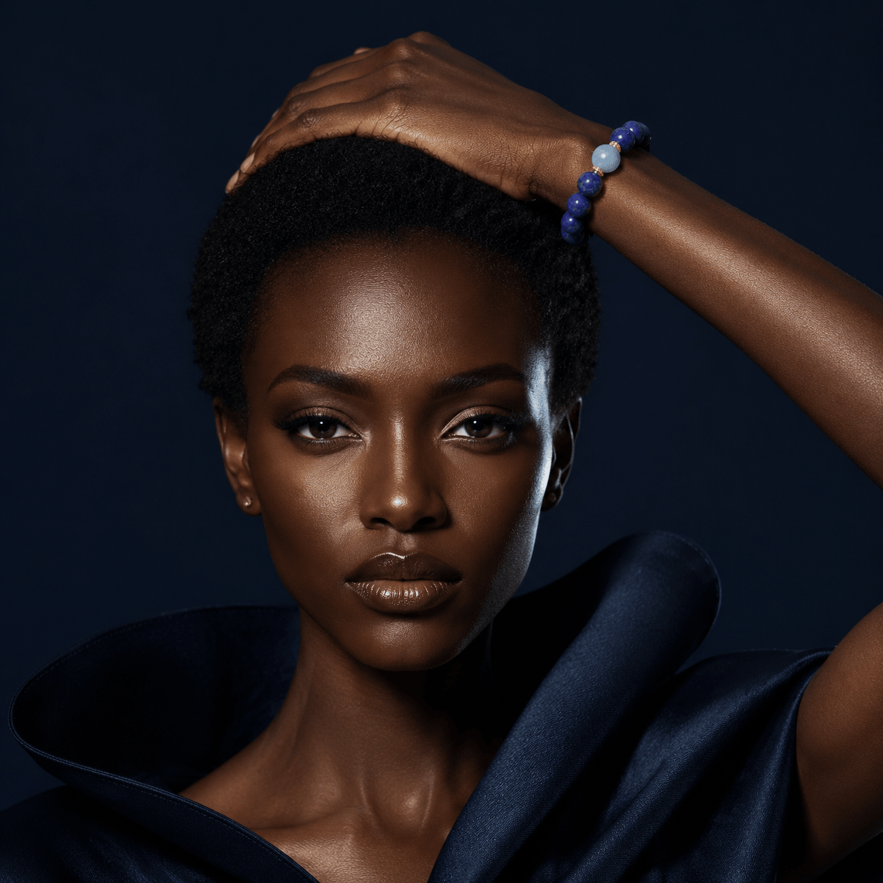 Model wearing a Lapis Lazuli bracelet with Aquamarine accent and gold-tone details